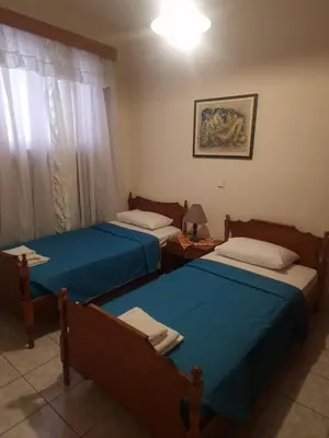 a bedroom with two beds and a window at George's & Amalia's appartments 2 in Afantou