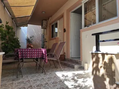 a patio with a table and chairs on it at George's & Amalia's appartments 2 in Afantou
