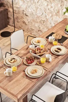 a wooden table with plates of food on it at Anar Villas Rhodes in Koskinou