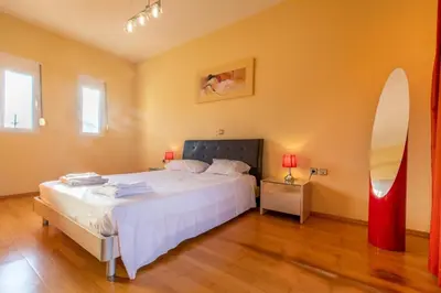 a bedroom with a bed and a surfboard on the wall at Rose Garden House in Kremasti