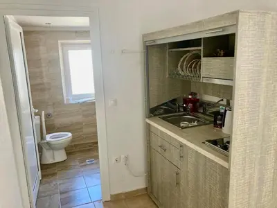 a small bathroom with a sink and a toilet at PALS Studios Lindos in Líndos