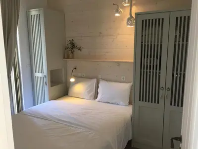 a bed with white sheets and pillows in a bedroom at Auberge Kalopetri in Kamiros