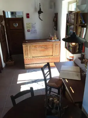 a room with a desk and a table with a laptop at Auberge Kalopetri in Kamiros