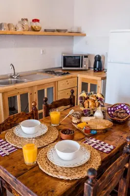 a wooden table with plates of food on it in a kitchen at Villa Lindos Muse in Líndos