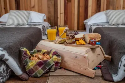 a table with a tray of bread and orange juice at Villa Lindos Muse in Líndos