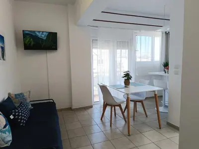 a living room with a white table and chairs at Nautilus City Studios & Apartments in Rhodes Town