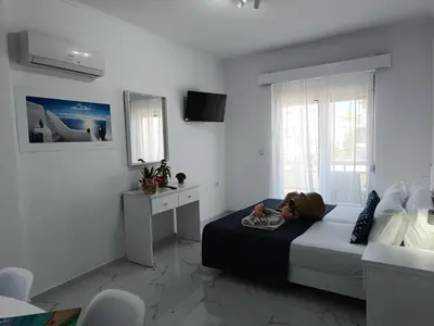 a bedroom with a bed in a white room at Nautilus City Studios & Apartments in Rhodes Town