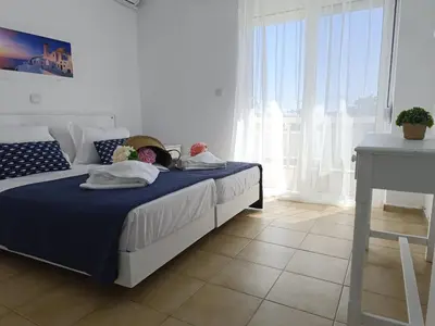 a bedroom with a bed with two stuffed animals on it at Nautilus City Studios & Apartments in Rhodes Town