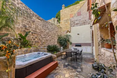 a hot tub in the courtyard of a building at Casa Della vita Suite ,Old Town Rhodes in Rhodes Town