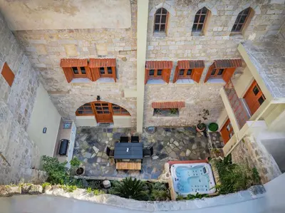 an aerial view of a building with a table and a pool at Casa Della vita Suite ,Old Town Rhodes in Rhodes Town