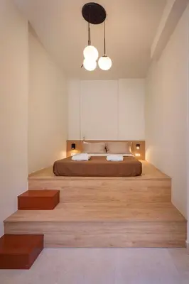 a bedroom with a large bed with wooden floors at Casa Della vita Suite ,Old Town Rhodes in Rhodes Town