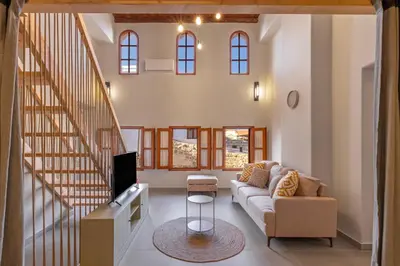 a living room with a couch and a tv at Casa Della vita Loft ,Rhodes Old town in Rhodes Town