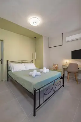 a bedroom with a bed and a desk and a chair at Casa Della vita Loft ,Rhodes Old town in Rhodes Town