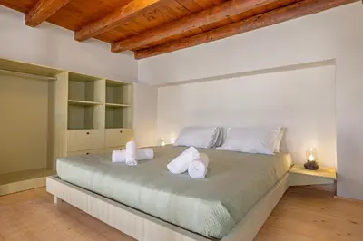 a bedroom with a large bed with towels on it at Casa Della vita Loft ,Rhodes Old town in Rhodes Town