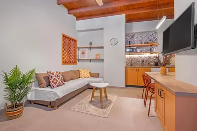 a living room with a couch and a kitchen at Casa Della vita apartment ,Old Town Rhodes in Rhodes Town