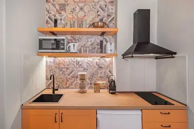 a small kitchen with a sink and a microwave at Casa Della vita apartment ,Old Town Rhodes in Rhodes Town