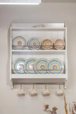 a shelf filled with plates and bowls on a wall at Casa Della vita apartment ,Old Town Rhodes in Rhodes Town
