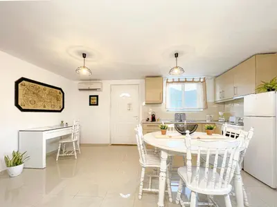 a kitchen with a table and chairs in a room at LA Casa Di Lusso N6 -Adults Only in Kolimbia
