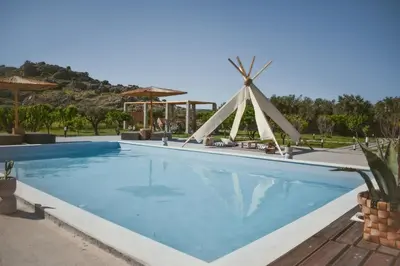 a pool at a resort with a windmill at LA Casa Di Lusso N6 -Adults Only in Kolimbia