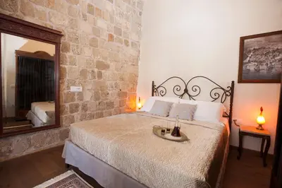 a bedroom with a bed with a large mirror at Porolithos Boutique Hotel in Rhodes Town
