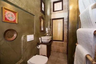 a bathroom with a toilet and a sink at Porolithos Boutique Hotel in Rhodes Town
