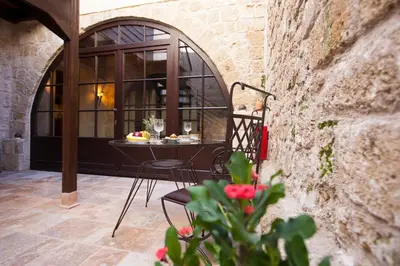 a patio with a table and chairs in a building at Porolithos Boutique Hotel in Rhodes Town