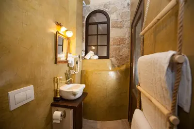 a bathroom with a sink and a mirror at Porolithos Boutique Hotel in Rhodes Town