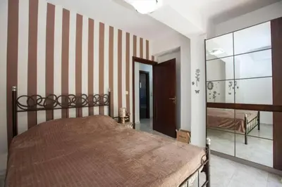 a bedroom with a bed and a large mirror at Natural Quiet Accommodation 2 in Kalithies