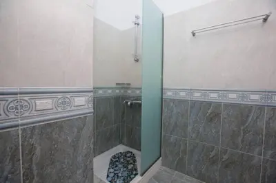 a bathroom with a shower with a glass door at Natural Quiet Accommodation 2 in Kalithies
