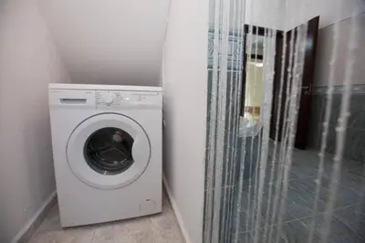 a washer and dryer in a corner of a room at Natural Quiet Accommodation 2 in Kalithies