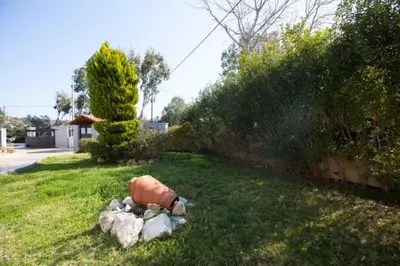 a garden with a fire hydrant in the grass at Natural Quiet Accommodation 2 in Kalithies