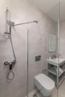 a bathroom with a shower and a toilet and a sink at Lindos orchid villa in Líndos