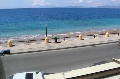 a road next to the ocean with a beach at Sea Pearl Luxury Apartment in Rhodes Town