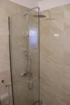 a shower with a glass door in a bathroom at Sea Pearl Luxury Apartment in Rhodes Town