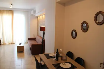 a living room with a table and a couch at Sea Pearl Luxury Apartment in Rhodes Town