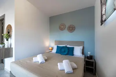 a bedroom with a large bed with two pillows at Aperanto Galazio Apartment in Archangelos