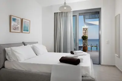 a bedroom with a bed and a view of the ocean at Villa Crystal with swimming pool in Lindos in Líndos