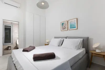 a bedroom with a white bed with a brown towel on it at Villa Emerald with swimming pool in Lindos in Líndos