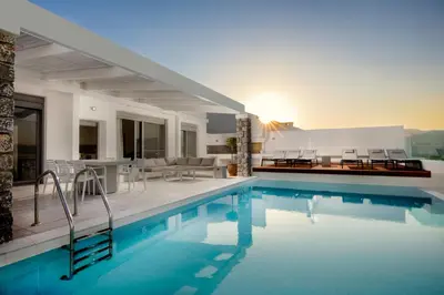 a house with a swimming pool and a dining area at Villa Emerald with swimming pool in Lindos in Líndos