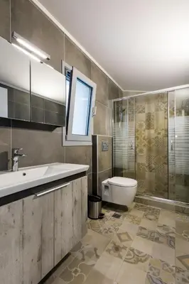 a bathroom with a sink and a toilet at Villa Emerald with swimming pool in Lindos in Líndos