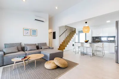a living room with a couch and a table at Villa Estella with pool & jacuzzi in Lindos in Líndos