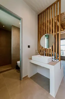 a bathroom with a sink and a mirror at Lindos Calmare Suites in Líndos