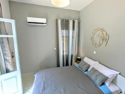 a bedroom with a bed and a shower in it at Ritzi Apartment in Symi