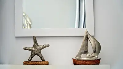 two metal objects on a shelf with a picture and a starfish at Ritzi Apartment in Symi