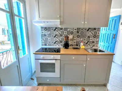 a kitchen with a sink and a counter top at Ritzi Apartment in Symi