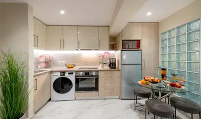 a kitchen with a table and a dishwasher at CostaMare BoutiqueApart-where luxury meets comfort in Rhodes Town