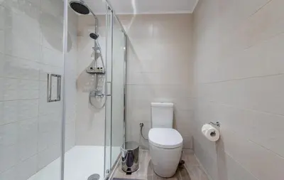 a bathroom with a toilet and a glass shower at CostaMare BoutiqueApart-where luxury meets comfort in Rhodes Town