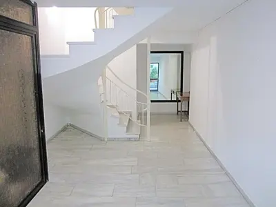a staircase in a house with white walls and a tile floor at CostaMare BoutiqueApart-where luxury meets comfort in Rhodes Town
