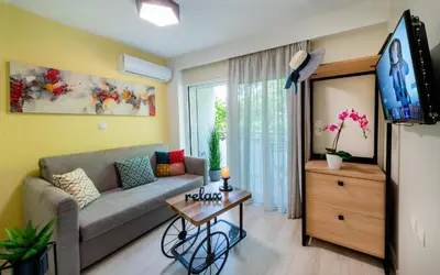 a living room with a couch and a tv at CostaMare BoutiqueApart-where luxury meets comfort in Rhodes Town