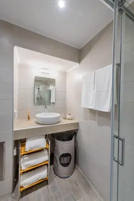 a bathroom with a sink and a shower at CostaMare BoutiqueApart-where luxury meets comfort in Rhodes Town